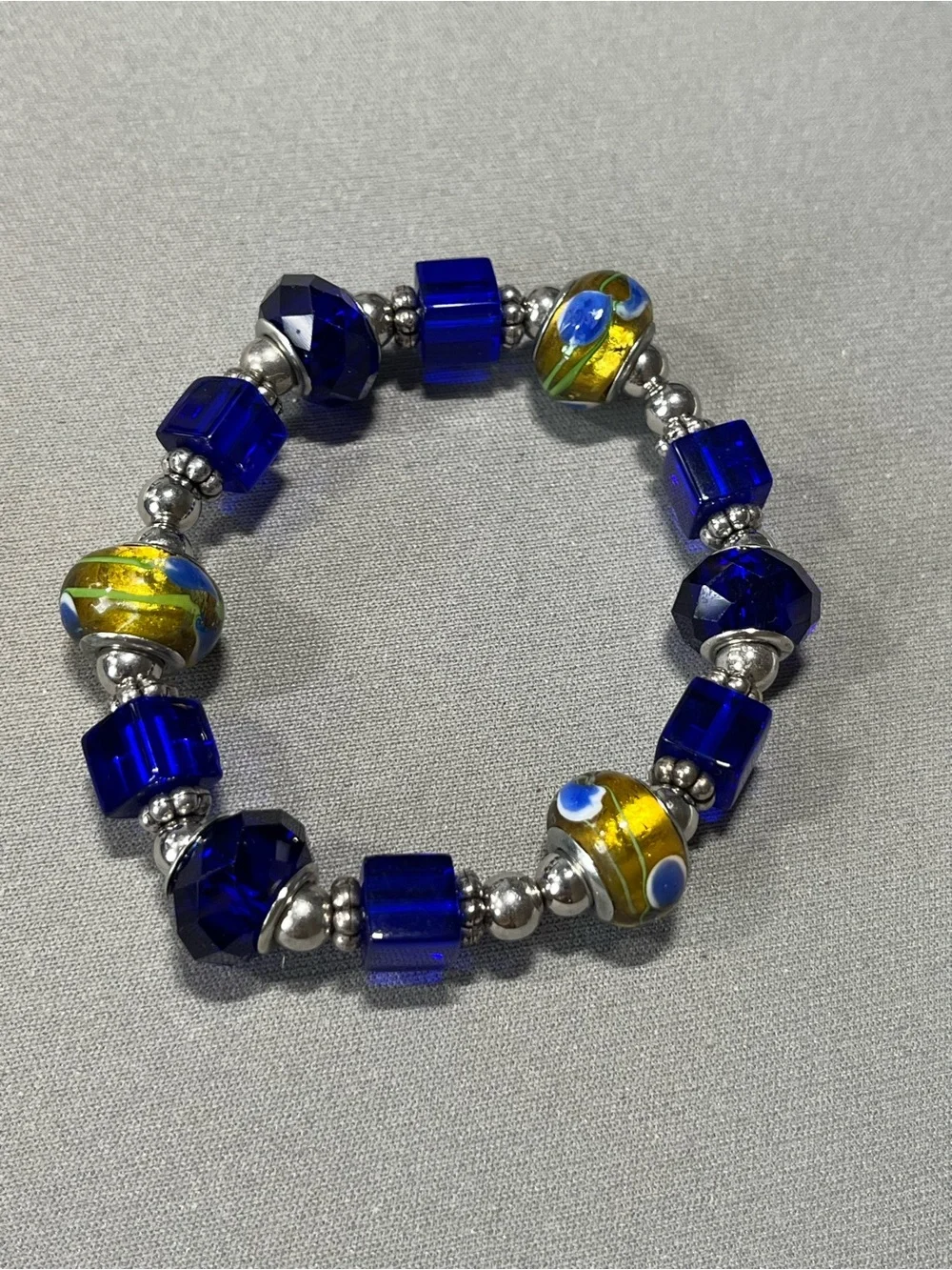 NWOT beautiful blue and yellow plastic beads with silver tone beads in between.